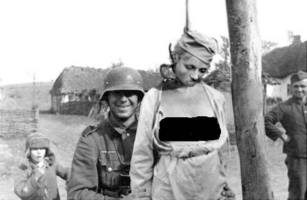 What a horrible Nazi, smiling about this awkward hanged woman!