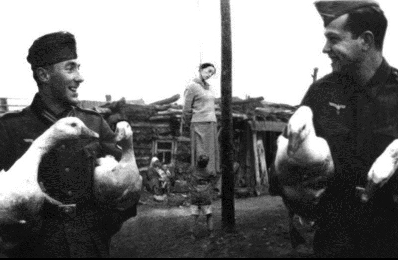 Look at these evil Nazis.  Laughing at the poor peasant woman they just killed for her goats.  What a couple of scoundrels. 