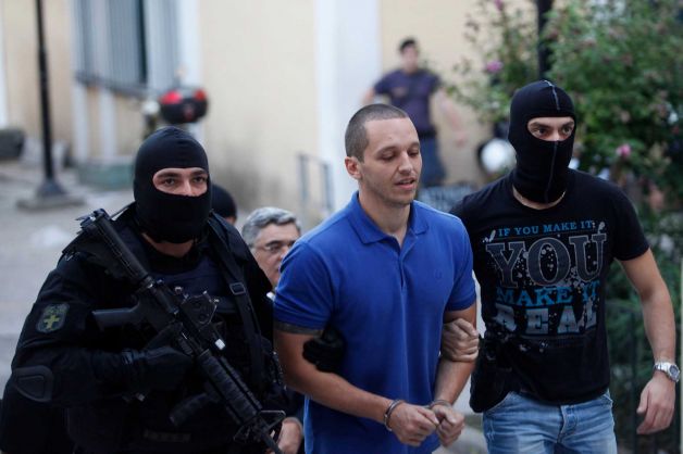 Ilias Kasidiaris being hauled off by masked thugs.
