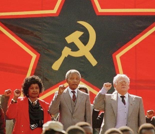 Whinny, Nelson and his Jew comrade Joe Slovo, chanting in front of a communist flag that they are going to kill all White people.