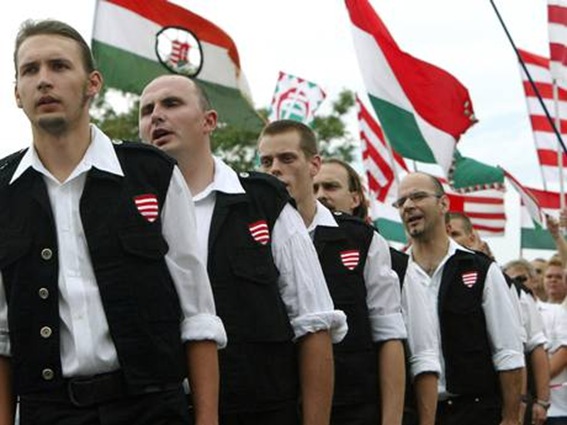 Members of Jobbik take an oath to join the Magyar Garda, a group pledging to 'defend Hungary physically, morally and mentally