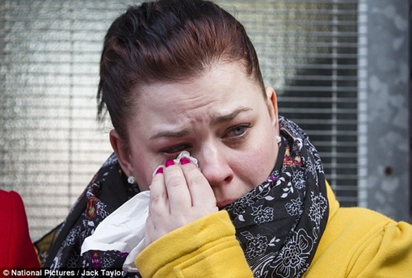 Mother Carly Wells tearful outside of West London Coroner's Court today, as her sister gives a statement on behalf of the family. Her family is considering legal action against the Kingston NHS Trust