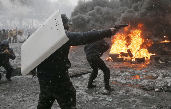The is a protester firing a handgun at the paramilitary forces. Just a "clash with the police."