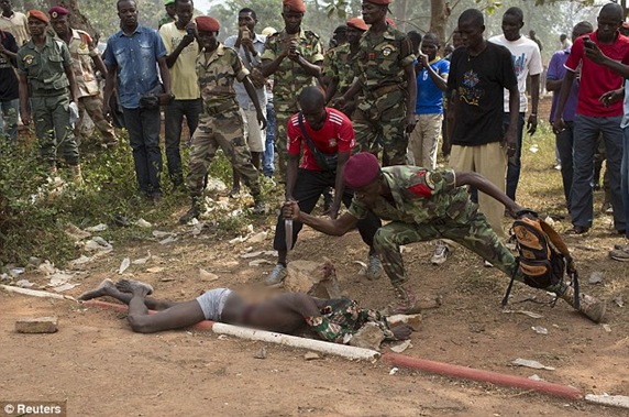 A Central African Army soldier stabs the man who was accused of joining the ousted Seleka rebel group