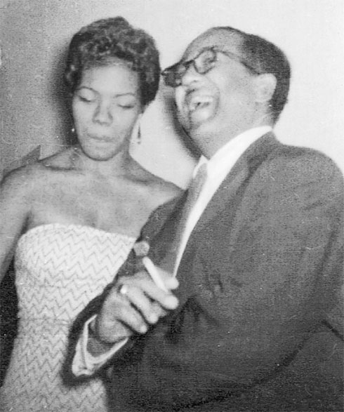 A young, beautiful Maya Angelou with Langston Hughes, not long after her career as a sex worker—guess she didn’t think his joke was that funny? (Photo via mayaangelou.com)