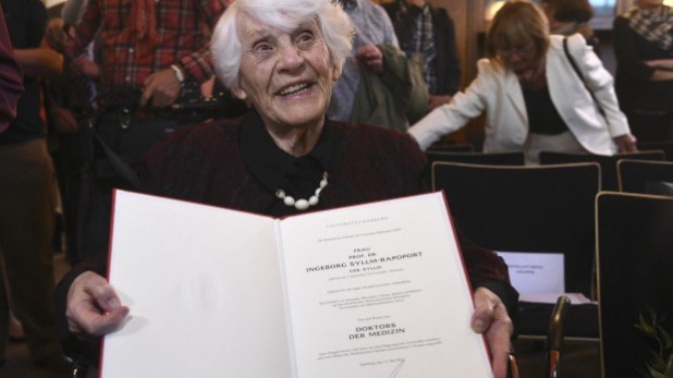 This lying old commie kike holds up the very menu she was to appear on once they hauled her out of the oven.