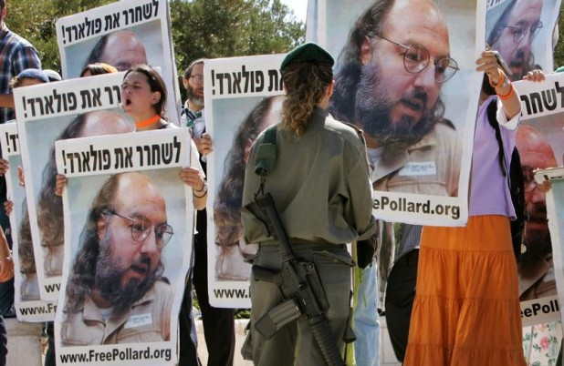 Israeli protesters hold posters of Jonathan Pollard in front of Israeli Prime Minister's office in Jerusalem. Israeli protesters hold posters of Jonathan Pollard, who was convicted for spying on the United States in 1987, in front of the Israeli Prime Minister's office in Jerusalem June 19, 2005. The protest, calling for Pollard's release from a US prison, took place during U.S. Secretary of State Condoleezza Rice's meeting with Israeli Prime Minister Ariel Sharon. REUTERS/Ammar Awad - RTREUY7