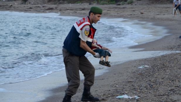 This is in Turkey. The man holding the child is Turkish. This is all a gigantic hoax.