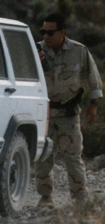 [Dude hiding behind car]