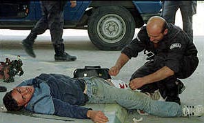 Serbian policeman assisting wounded